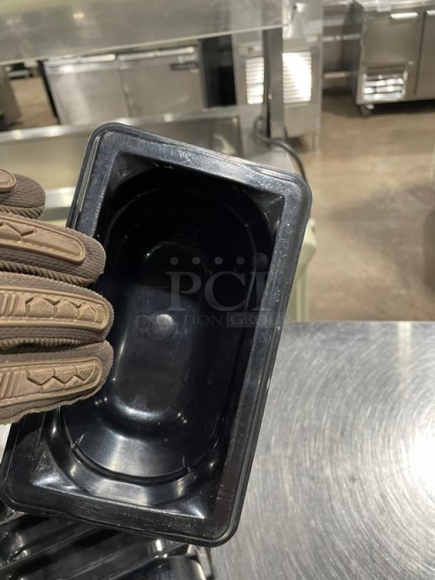 Vollrath commercial black food pan in excellent condition, rectangular shape, durable plastic, with visible brand imprint inside.