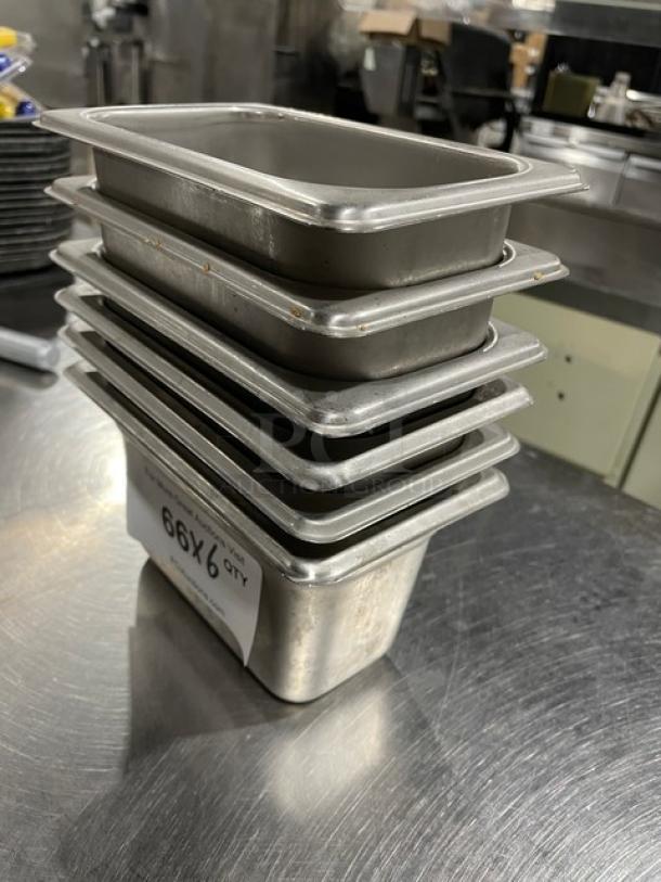 Don commercial stainless steel hotel pans, stack of six, used condition. Label indicates "6X Your Bid."