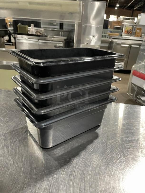 Cambro commercial black food pans, stack of five, durable plastic, excellent condition, for professional kitchen use.