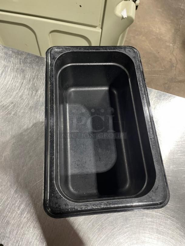 Cambro commercial black food pan in good condition, rectangular shape, durable plastic, ideal for kitchen use.