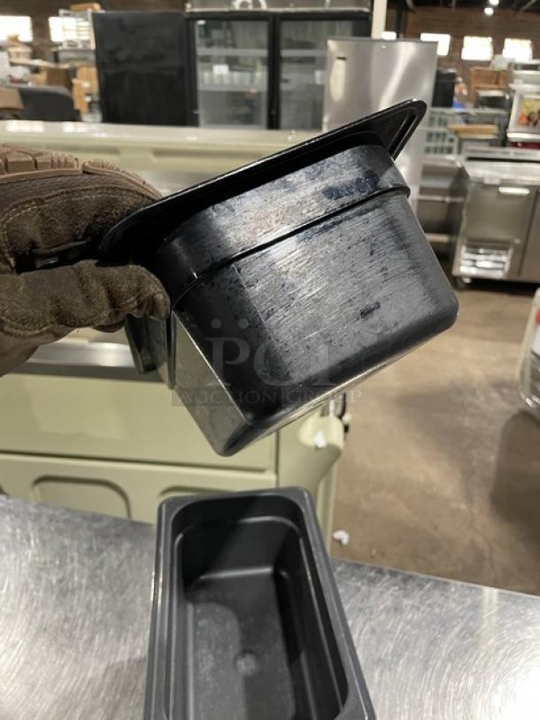 Cambro commercial black food pan, durable plastic, visibly used with scratches. Ideal for catering or kitchen use. Auction lot of five.