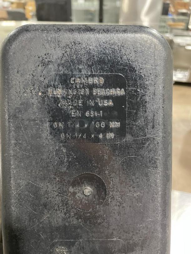 Cambro commercial black food pan with visible labels indicating "Made in USA" and dimensions 1/4 x 4 inches. Used condition.
