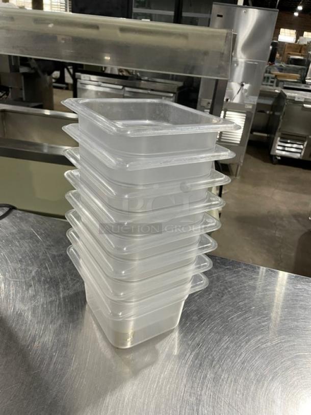 Vigor commercial clear polycarbonate food pans, stack of eight, rectangular, durable, used in good condition.