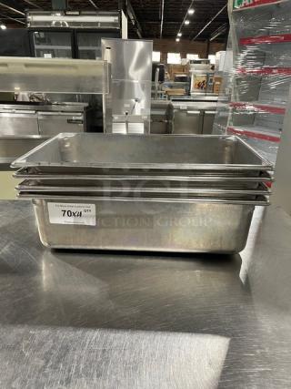 Commercial stainless steel hotel pans, set of 4, in good condition. Visible label reads "70xQty." Ideal for steamtable use.