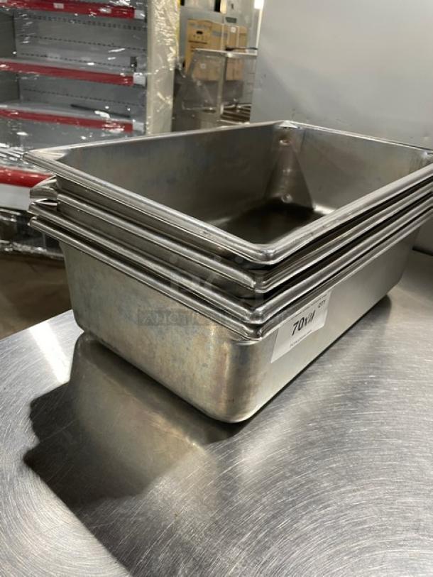 Stack of commercial stainless steel hotel pans, gently used, tallied at lot 70, perfect for steam table settings.