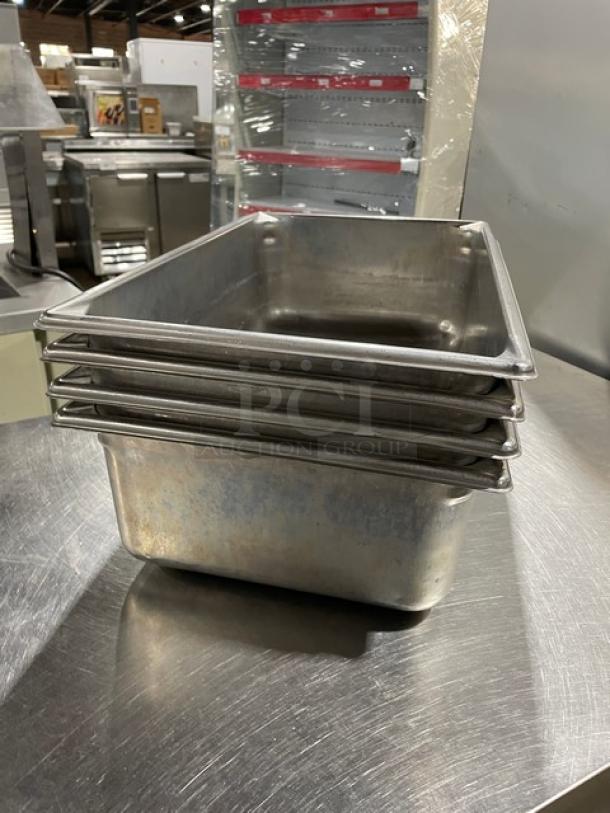 Commercial stainless steel steamtable pans, stack of four, used condition. Durable, versatile for hotel or catering use.