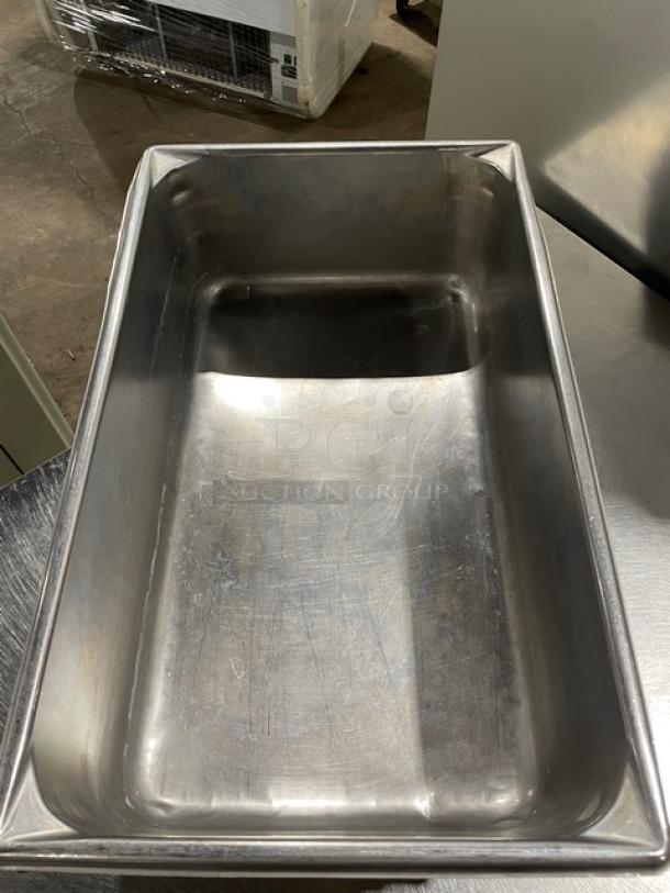 Commercial stainless steel hotel/steamtable pan, used condition. Rectangular shape, durable, ideal for catering or food service.