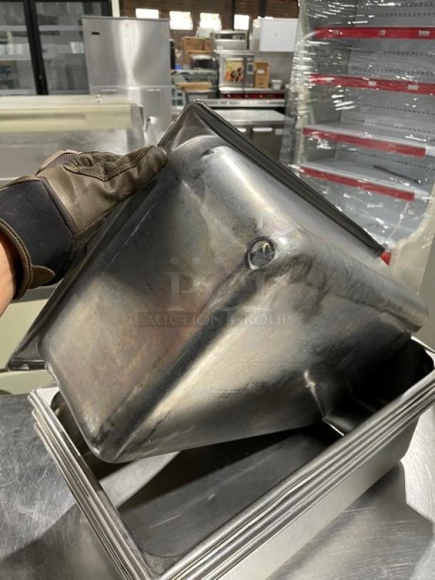 Stainless steel steamtable pan in used condition, showing wear. Ideal for commercial use, highlighting durability and utility.