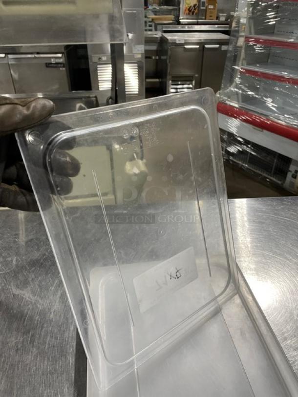 Clear Cambro polycarbonate food pan lid, rectangular shape, durable material, label indicating size; excellent condition.