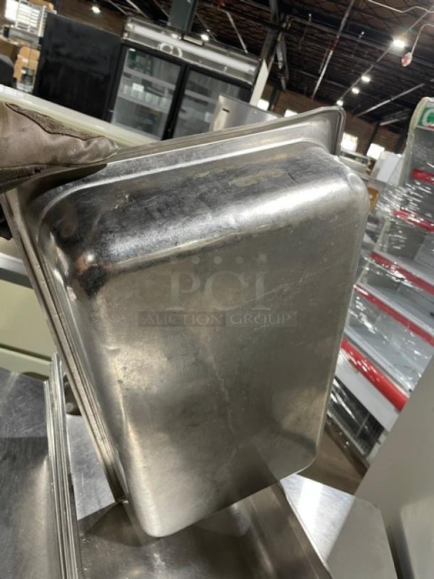 Stainless steel hotel steamtable pan, used, commercial grade, durable construction.