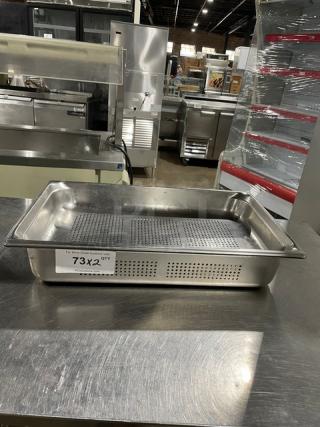 Commercial stainless steel perforated hotel pan, rectangular, excellent condition, labeled "73X2 QTY," on stainless steel countertop.