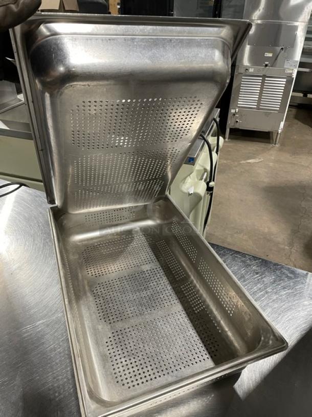 Commercial stainless steel perforated hotel/steamtable pan in used condition, showing inside and lid with ventilation holes.