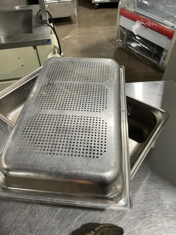 Commercial stainless steel perforated hotel/steamtable pan, rectangular, stackable, durable metal, used condition.