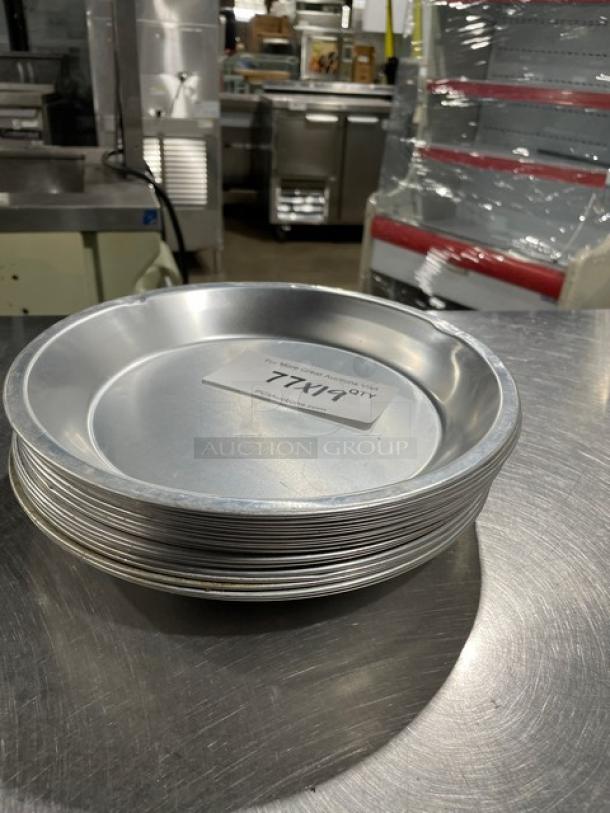Stack of commercial round pie pans, aluminum, pristine condition, 19 pieces. Marked "Lot 177 XL".