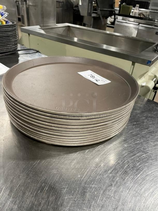 Commercial brown round fast food serving trays, stack of 12, durable plastic, excellent condition, marked for auction.