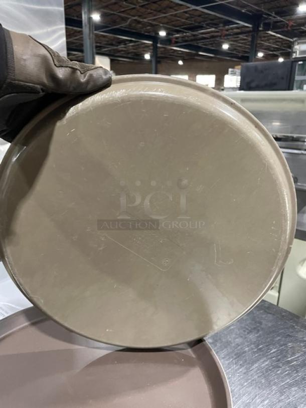 Commercial brown round fast food serving tray, durable plastic, lightly used, visible surface marks, sold as 12 per bid.