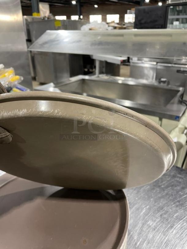 Commercial brown round fast food serving tray, stackable, used condition, measuring approximately 12 inches.