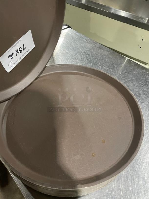 Commercial brown round fast food serving tray, multiple units, slight wear, labeled "12X" indicating quantity.
