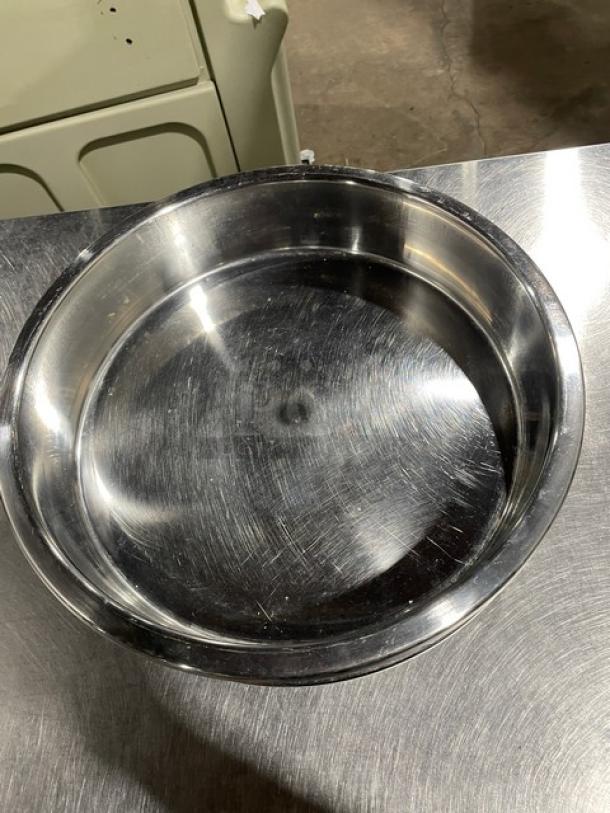 Commercial stainless steel round stacking baking pan, shine indicates good condition, suitable for professional kitchens.
