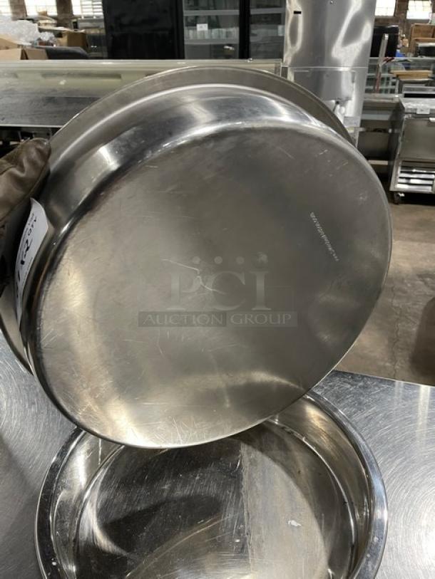 Commercial stainless steel round stacking/baking pan, polished finish, minor surface scratches, suitable for professional use.