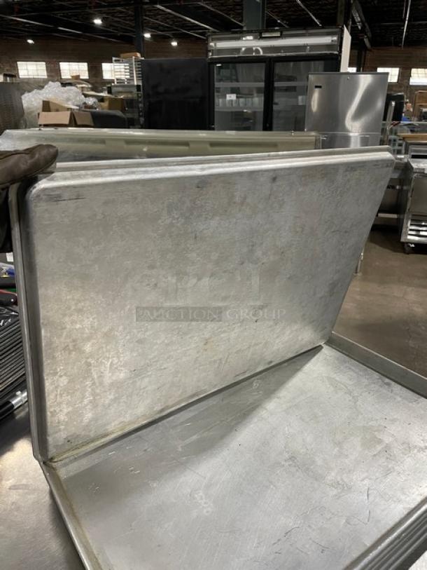 Commercial rectangular baking sheet pan, used condition, metallic finish, durable design for high-volume baking.
