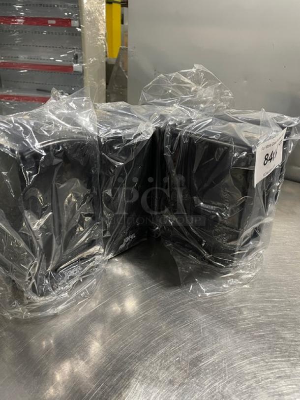 New Jofel black tall-fold napkin dispensers in plastic wrap, tabletop model on legs, 6 units available, excellent condition.