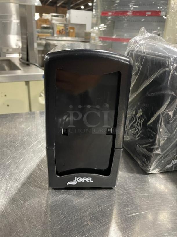 Jofel commercial black tall-fold napkin dispenser on legs, new condition, tabletop design with visible logo.