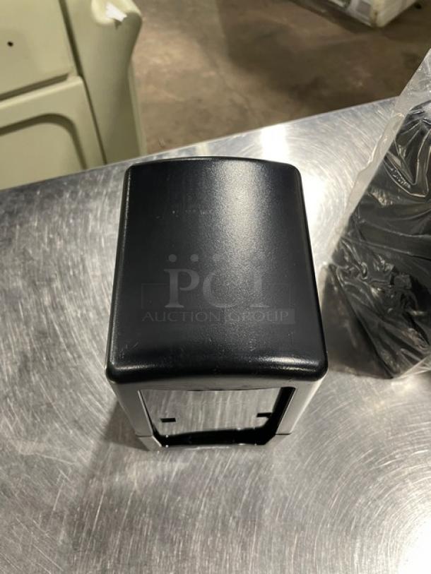 NEW Jofel black tabletop napkin dispenser with legs, tall-fold design, modern commercial style, excellent condition.