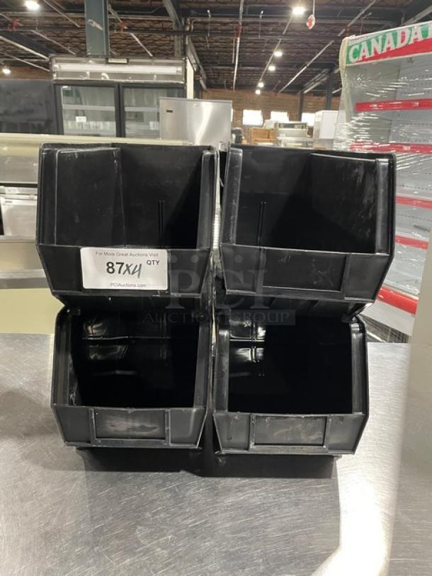 Commercial black countertop stackable condiment/utensil bin, four units, durable plastic, used condition, labeled "87X1 QTY".