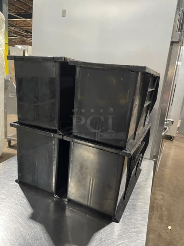 Commercial black stackable countertop condiment/utensil bins. Set of four, durable plastic, in good condition. Ideal for organization.