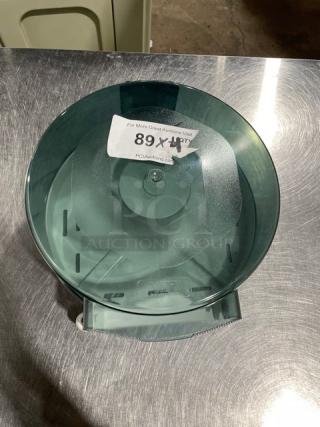 Wisconsin Tissue commercial smoke gray paper roll dispenser, round shape, wall-mounted; auction label attached.