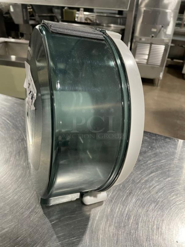 Wisconsin Tissue commercial smoke gray paper roll dispenser, durable design, side view. Visible model number label.