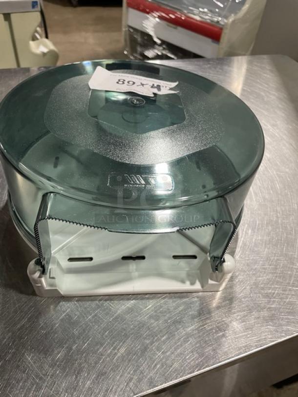 Wisconsin Tissue smoke gray paper roll dispenser in good condition, features transparent top and white base, model 89X.