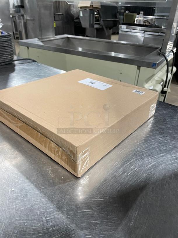 Brand new Thunder Group SLKR012 stainless steel knife rack in sealed cardboard packaging on metal surface.