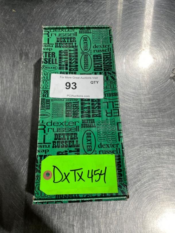 Brand new Dexter Russell Prodex Series stainless steel knife in box with black grip handle; labels indicate auction details.