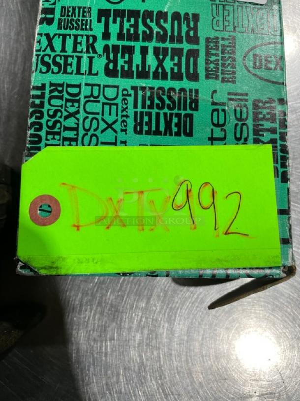 Brand new Dexter Russell Sani-Safe pie knife, Model S174, with stainless steel blade and black grip handle. Box marked "DxTx 992".