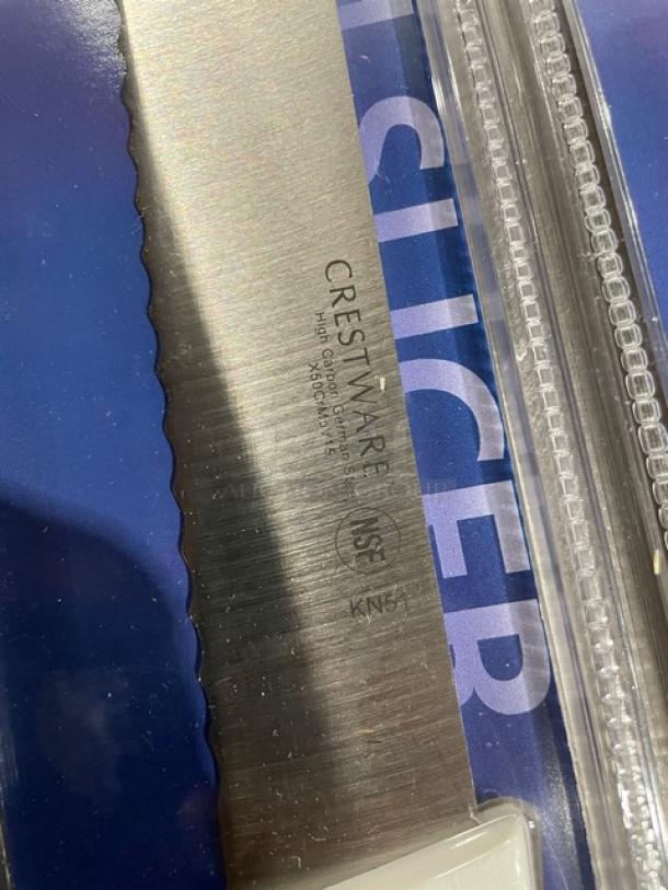 Brand new Crestware KN51 10" ham slicer with serrated German steel blade and white grip handle. NSF certified.