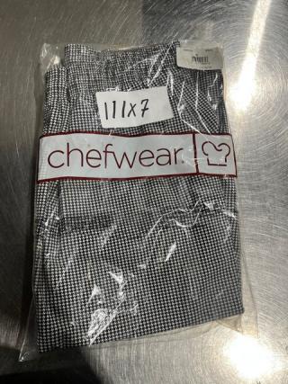 Brand new Chefwear CW11 medium-size chef pants in packaging. Black and white houndstooth pattern. Tags show "11x7".