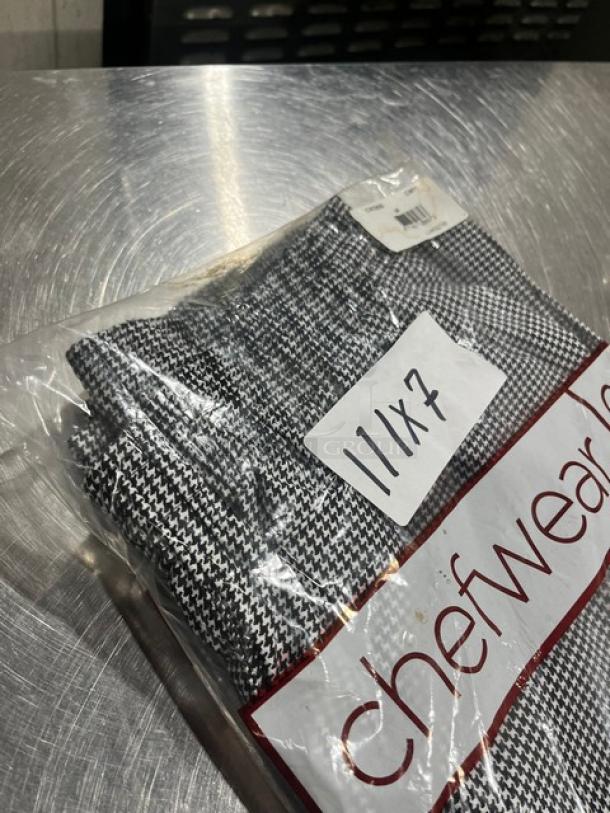 Brand new Chefwear CW11 medium-size chef pants in packaging. Houndstooth pattern, 7X bid multiplier label visible.