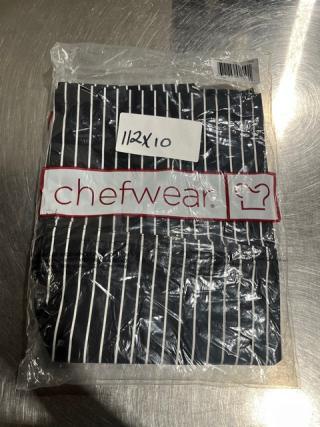 Brand new Chefwear CW35 black chalk-stripe chef pants in packaging. Label reads "12X10." High-quality, professional attire.