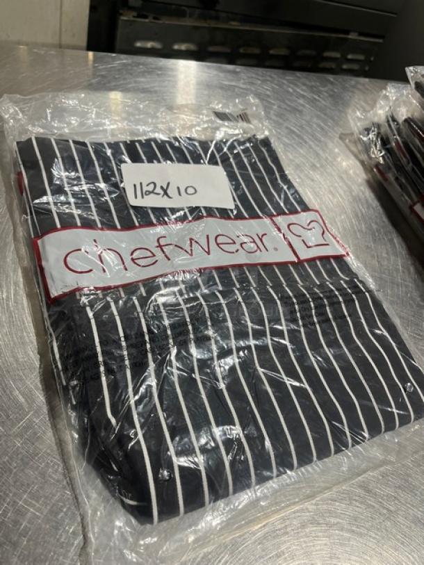 Brand new Chefwear CW35 black chalk-stripe chef pants, sealed in packaging. Pack labeled "112x10."