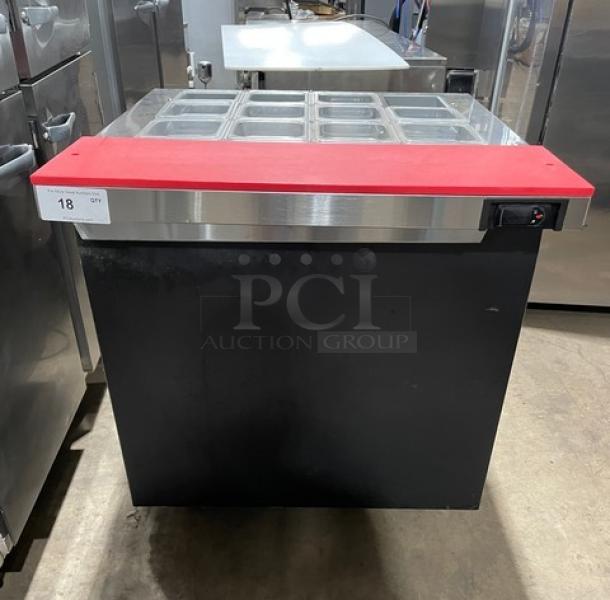 Continental SW32-12M black single door refrigerated prep table with stainless steel top, red cutting board, and clear food pans.