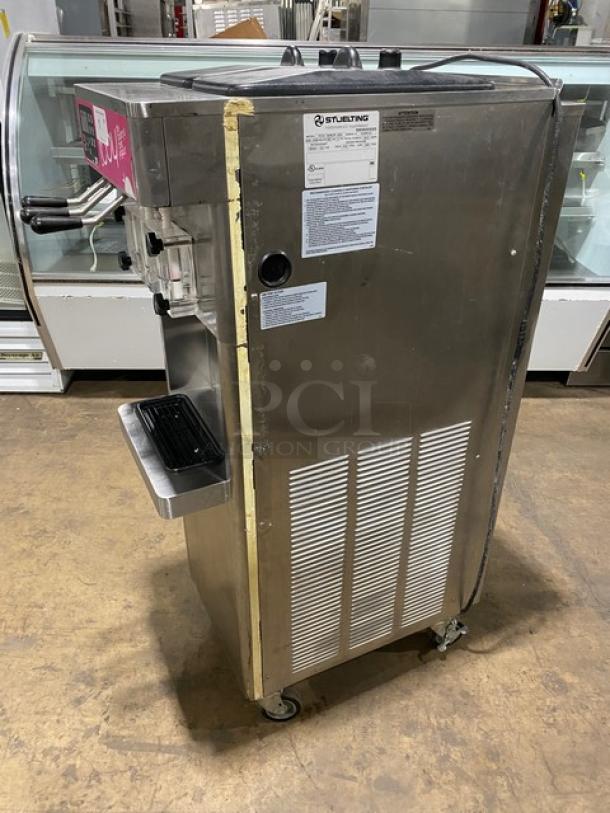 Stoelting F231 stainless steel twin flavor soft serve machine, 2 hoppers, drip tray, model F231-30912P-AD1, on casters.