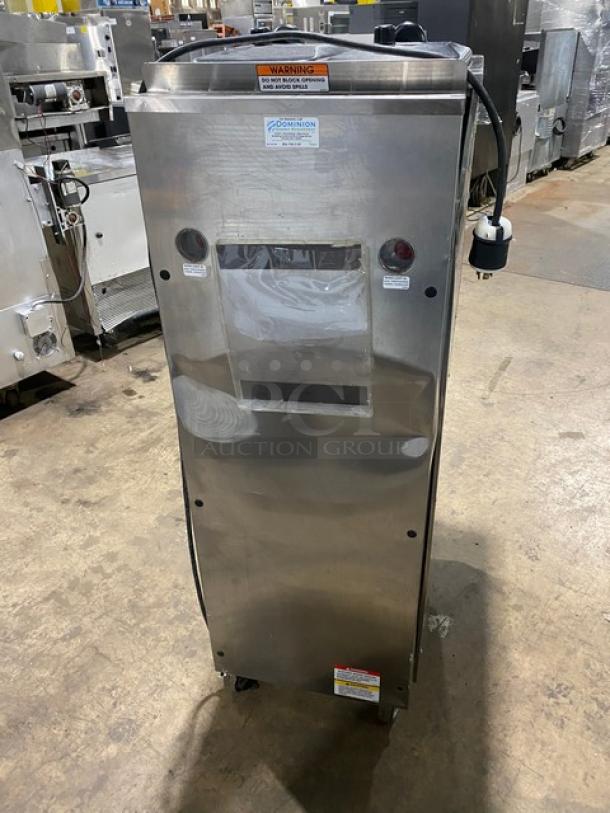Stoelting F23130912PAD1 stainless steel soft serve machine, twin/twist flavors, two hoppers, drip tray, on casters.