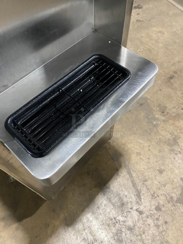 Stoelting F23130912PAD1 twin/twist flavor soft serve machine, stainless steel, with two hoppers and drip tray on casters.