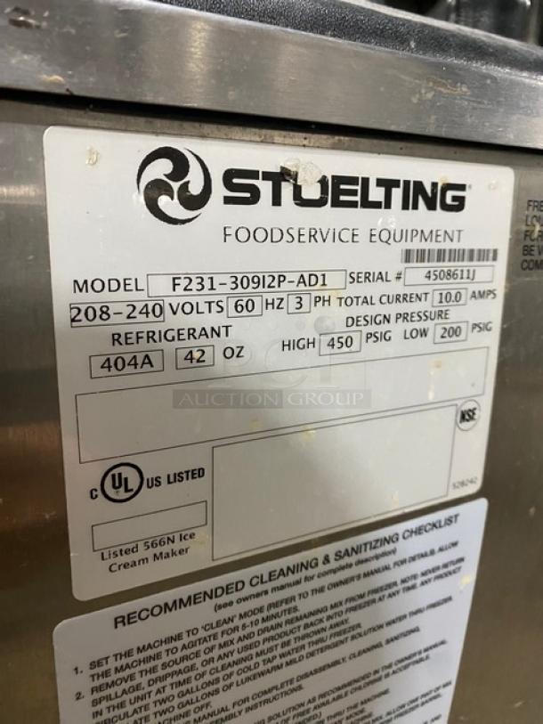 Stoelting F23130912PAD1 commercial soft serve machine, stainless steel, dual hoppers, 208-240V, 3 phase, on casters.