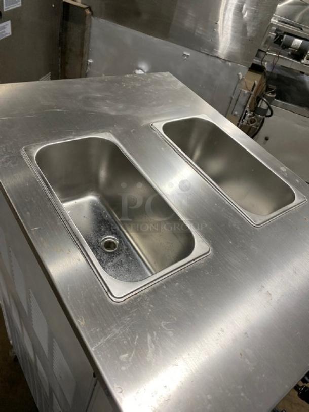Commercial stainless steel soft serve machine, model XY-25L, features twin/twist functionality, 110V, on casters, used.