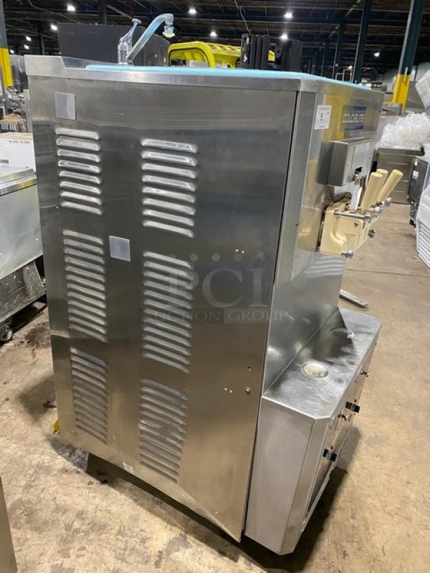ColdElite UF820-2 commercial stainless steel soft serve machine, 208V 3 phase, on casters, shown in a warehouse setting.