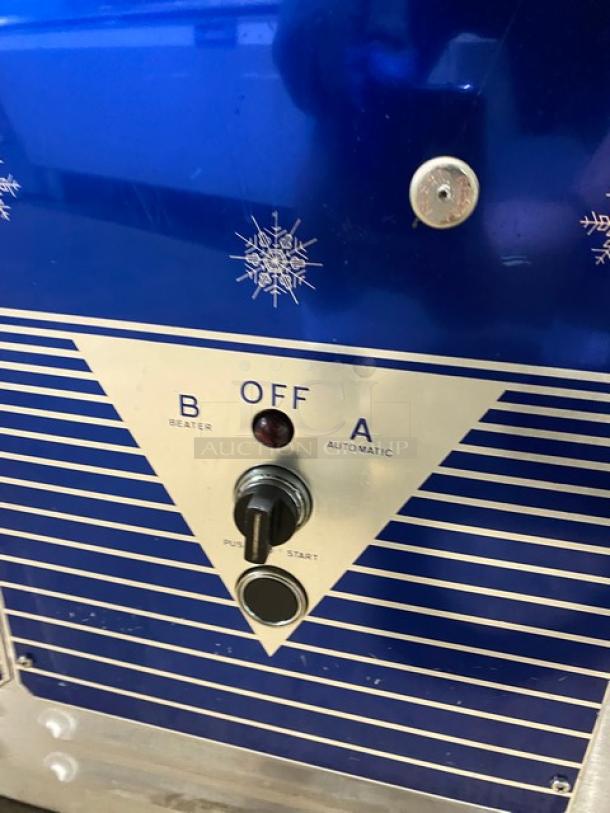 ColdElite UF8202 ice cream machine controls, showing beater and automatic settings. Stainless steel body with snowflake design.