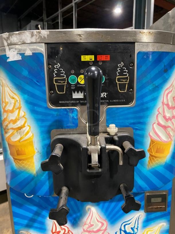 Taylor C707-33 stainless steel single flavor soft serve machine, with visible control panel and lever, good condition.